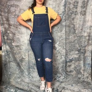 Distressed denim overalls
